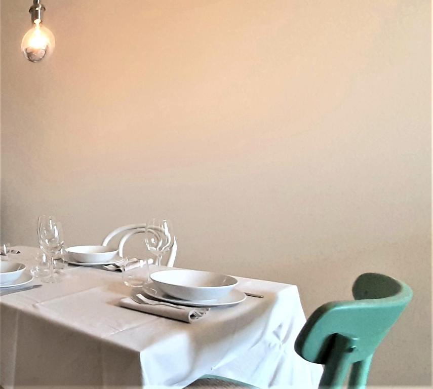 a white table with plates and bowls on top of it at Corte Mantovani - Appartamenti in Colà di Lazise