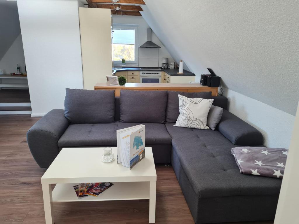 a living room with a couch and a table at Wohnung "Burgtiefe" in Bannesdorf auf Fehmarn in Fehmarn