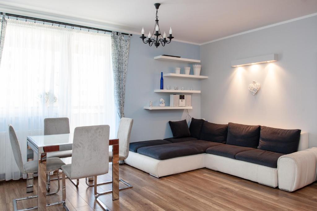 a living room with a couch and a table at Fantastic By The Sea Apartment Set Up With Love in Gdańsk
