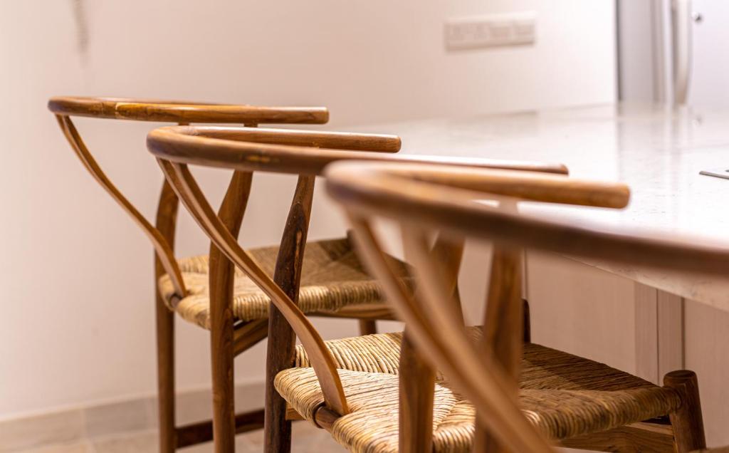 a pair of wooden chairs sitting at a table at The Courtyard Episkopi Guest Houses in Episkopi Limassol