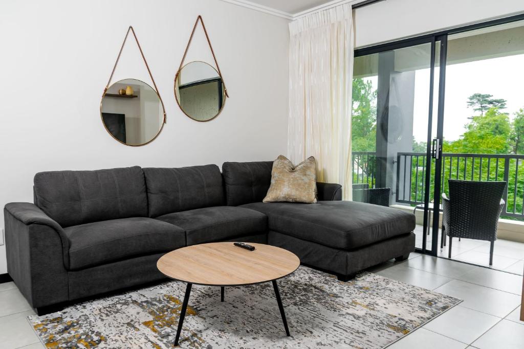 a living room with a couch and a table at Residence at Montego in Sandton