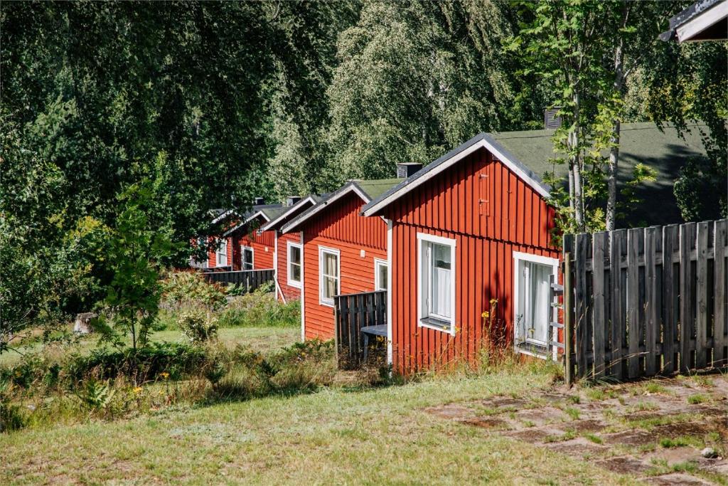 Undenäs的住宿－Holiday House with beautiful scenery near Göta Kanal，田野上的一排红房子
