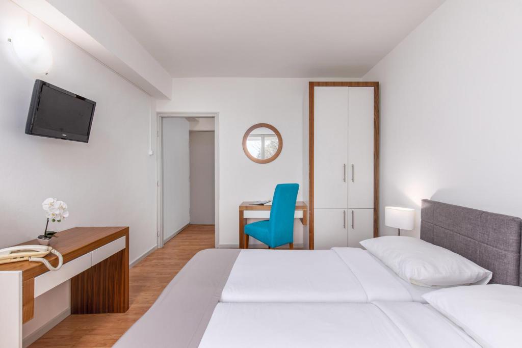 Postel nebo postele na pokoji v ubytování Hotel Zagreb