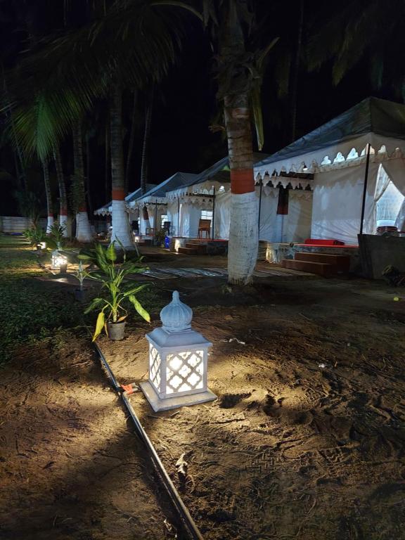 a white light sitting in the dirt at night at Blue Coast beach resort in Alibaug
