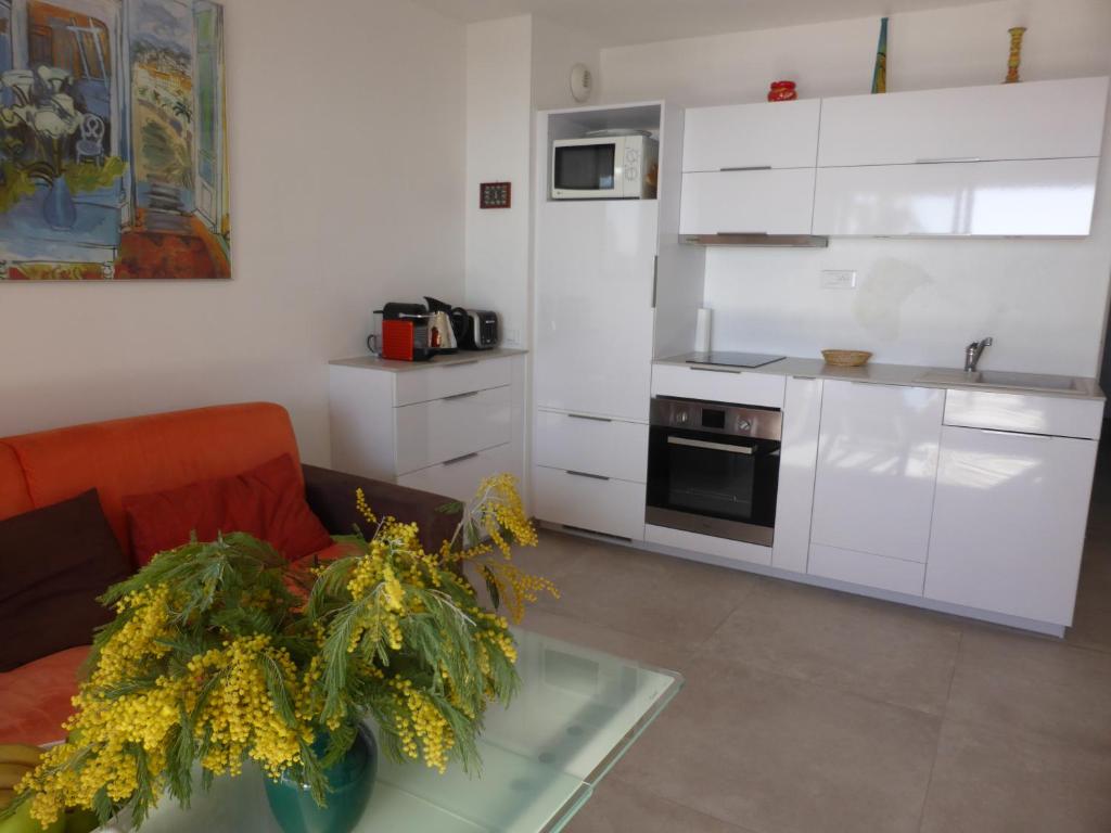 a living room with a couch and a kitchen at Plage de Miramar in Théoule-sur-Mer