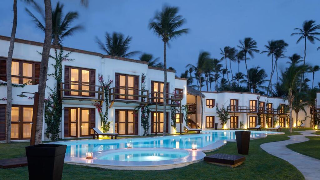 an exterior view of a building with a swimming pool at Blue Residence Hotel in Jericoacoara