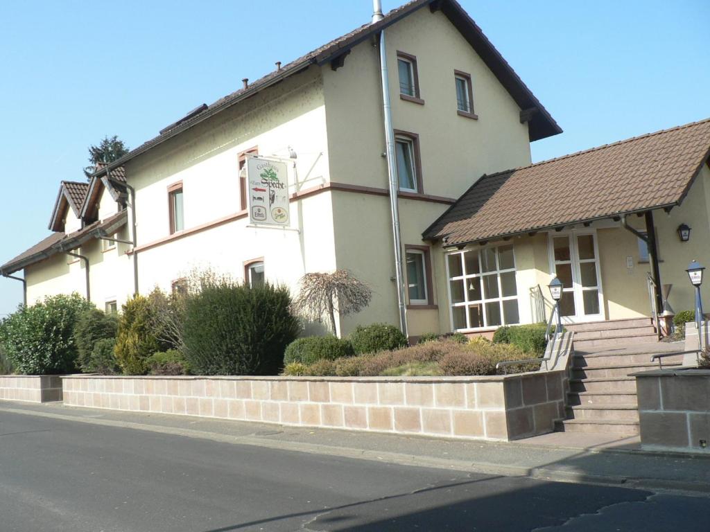 a white house on the side of a street at Gasthaus Zum Specht in Hösbach