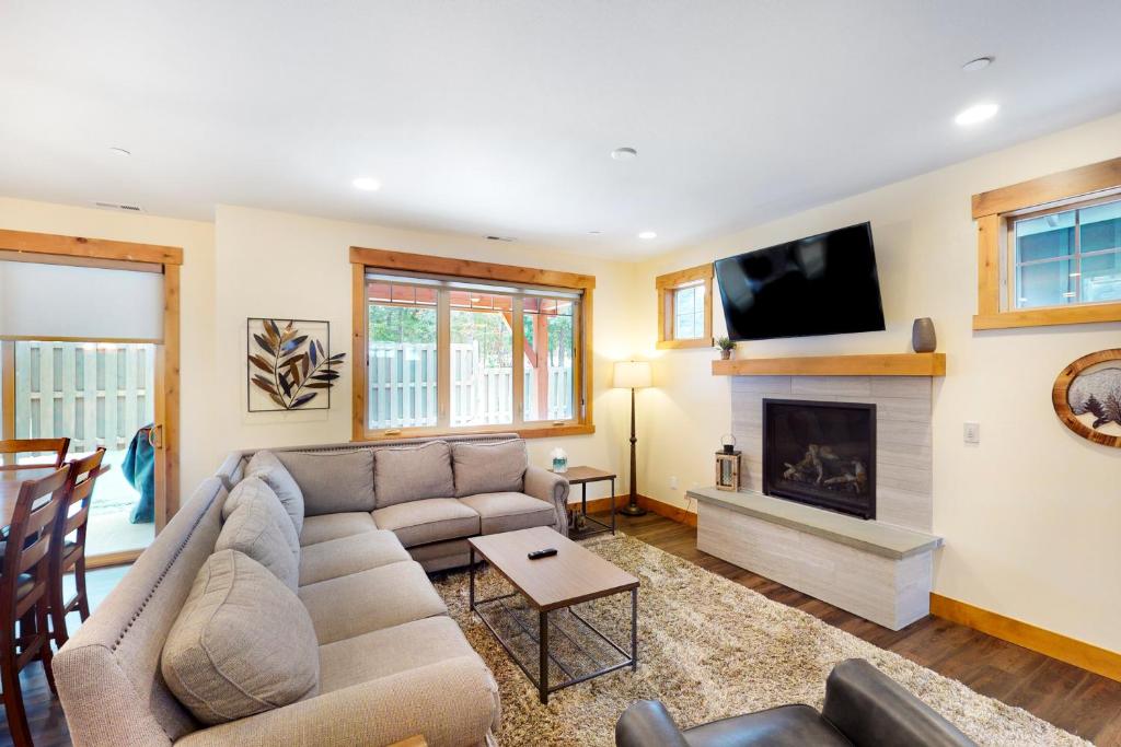a living room with a couch and a fireplace at Tranquility Trail at Suncadia Resort in Cle Elum