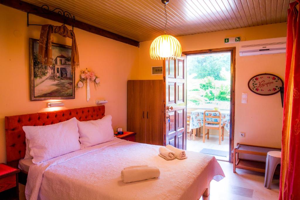 a bedroom with a bed with two towels on it at Alessandro in Sidari