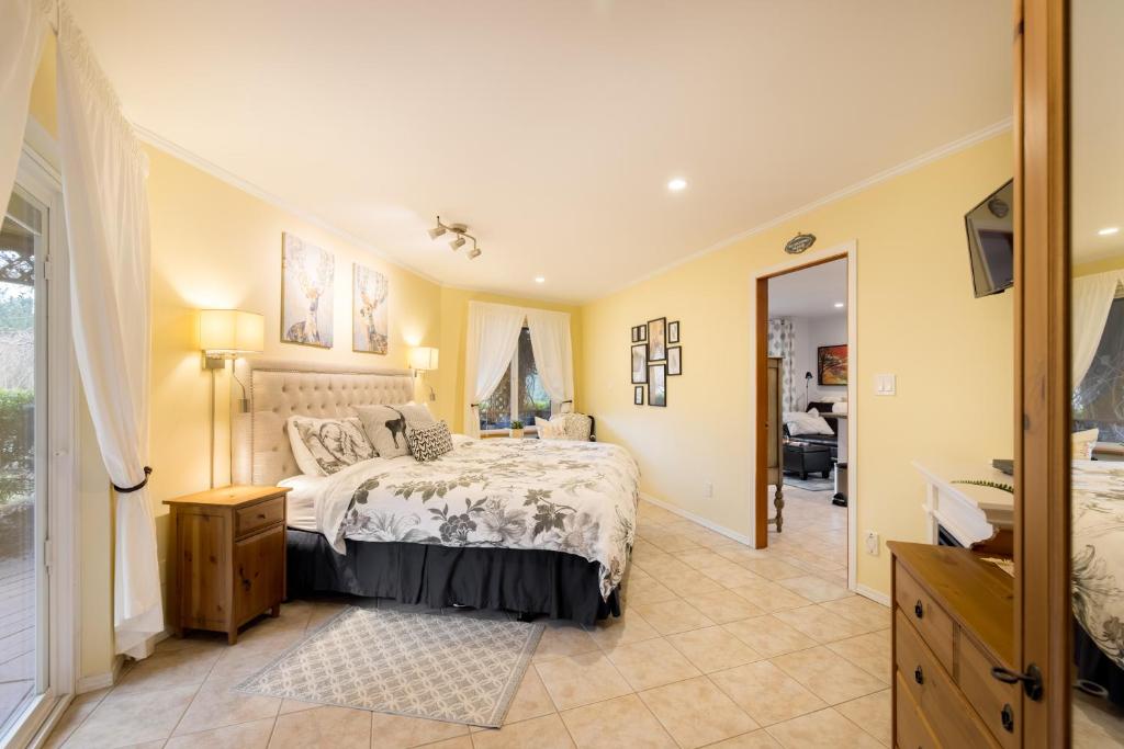 a bedroom with a bed and a bathroom at Enchanter Ocean View Suites in Madeira Park
