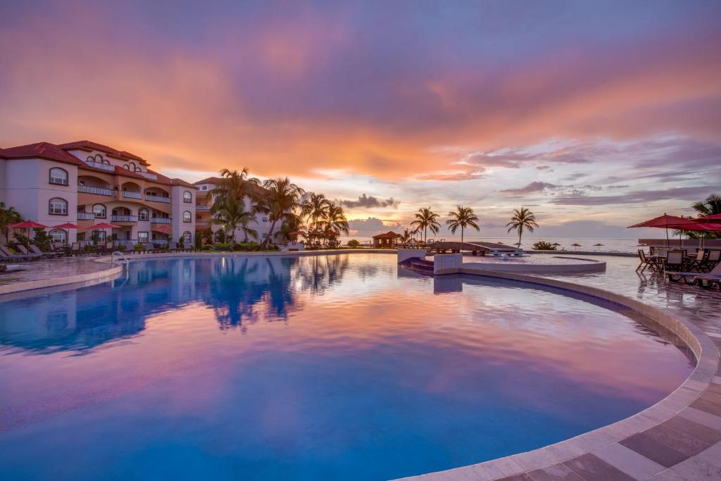 a large swimming pool in front of a resort at Grand Caribe Belize in San Pedro