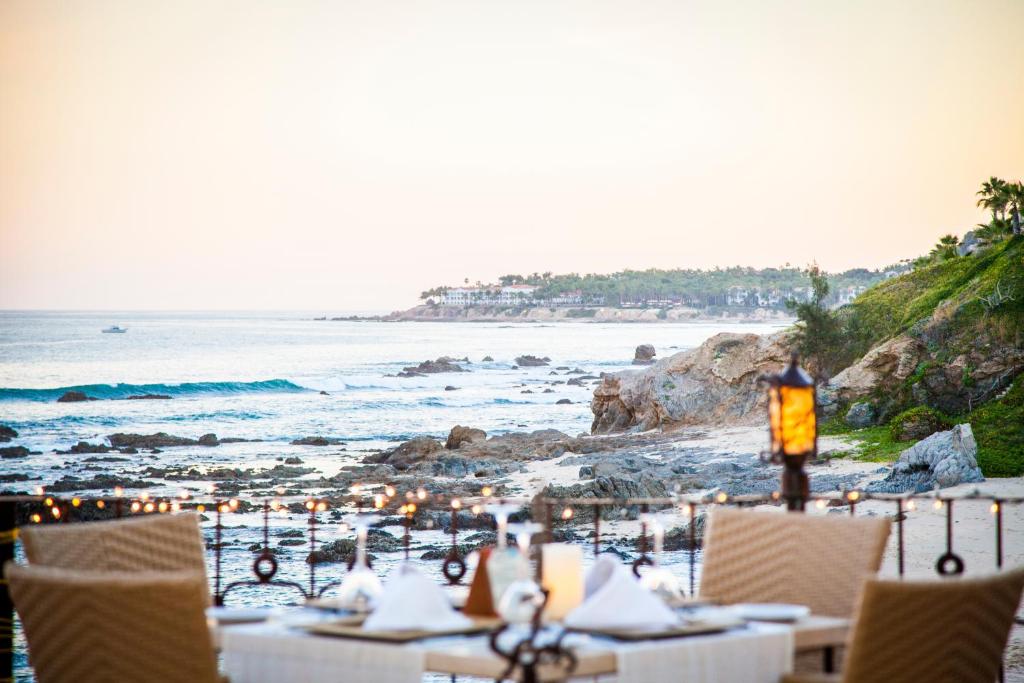 a restaurant on the beach with tables and chairs at Cabo Surf Hotel in San José del Cabo