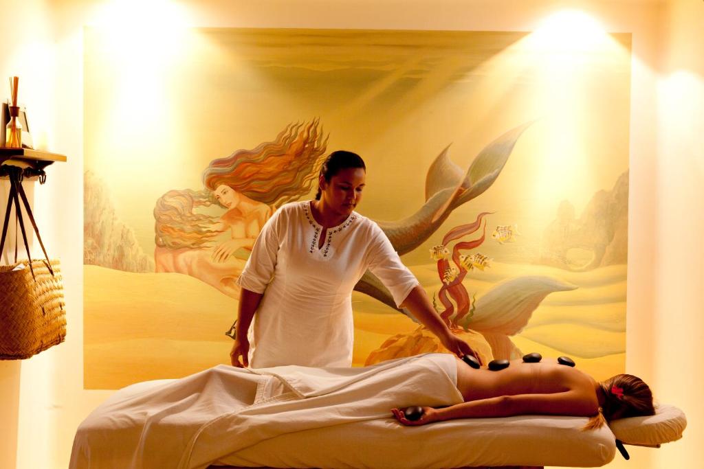 a man laying on a bed with a woman at Cabo Surf Hotel in San José del Cabo