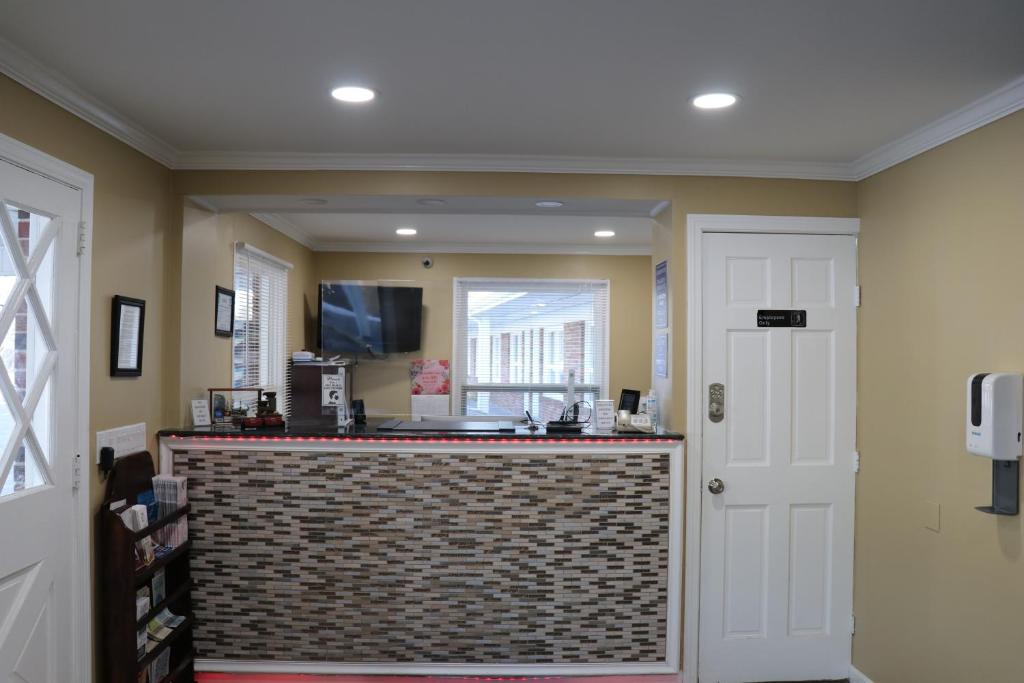 a kitchen with a counter and a window at Elite Inn in Moosup