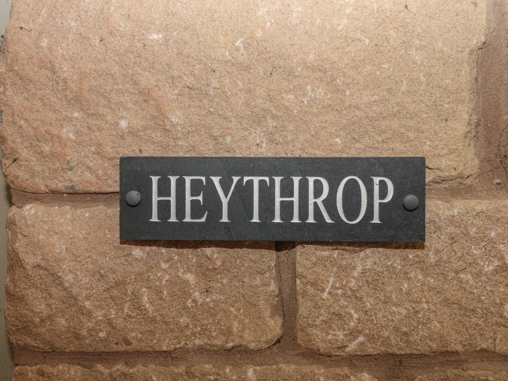 a sign that says kerithrop on a stone wall at Heythrop in Alton