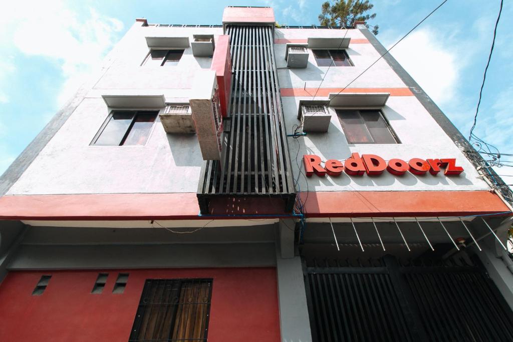 a red box sign on the side of a building at RedDoorz A&F C5 Pinagsama Taguig in Manila