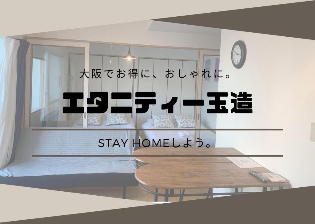 a room with a bed and a sign that says stay home at ETERNITY Tamatsukuri 301 in Osaka