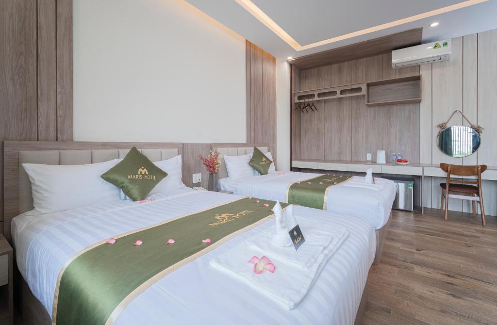 Postel nebo postele na pokoji v ubytování Maris Da Nang Hotel & Apartment