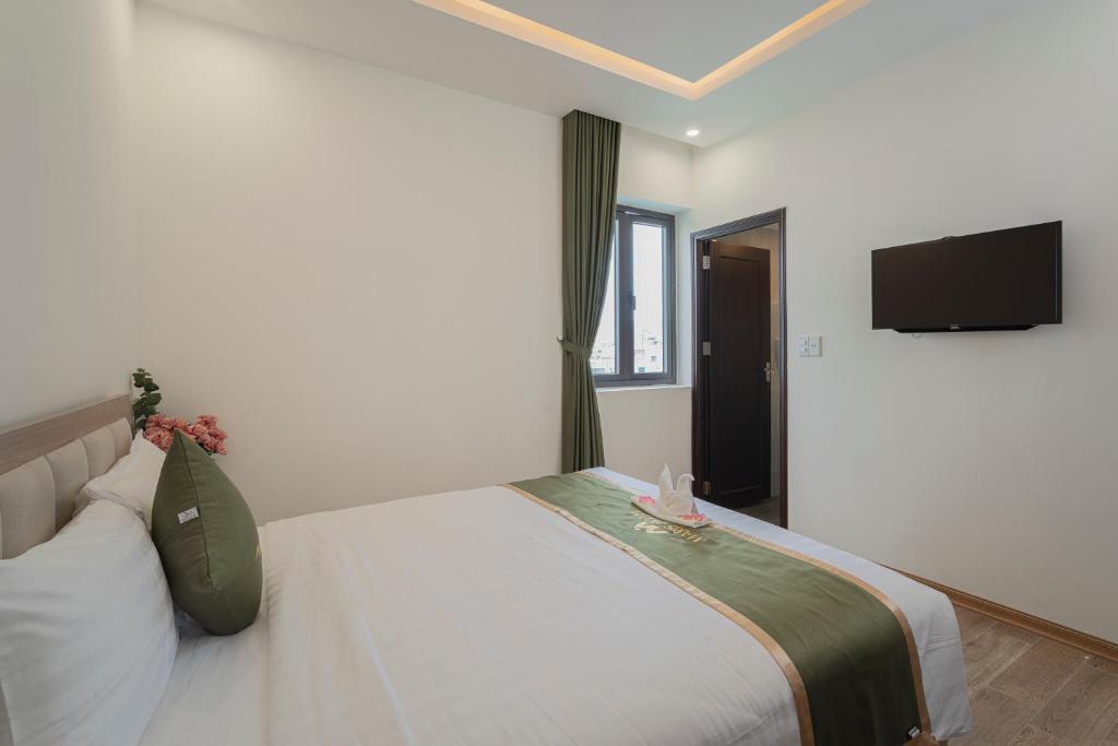 Postel nebo postele na pokoji v ubytování Maris Da Nang Hotel & Apartment