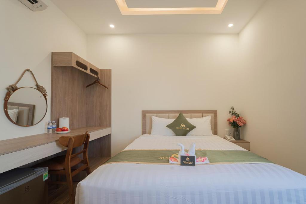 Postel nebo postele na pokoji v ubytování Maris Da Nang Hotel & Apartment