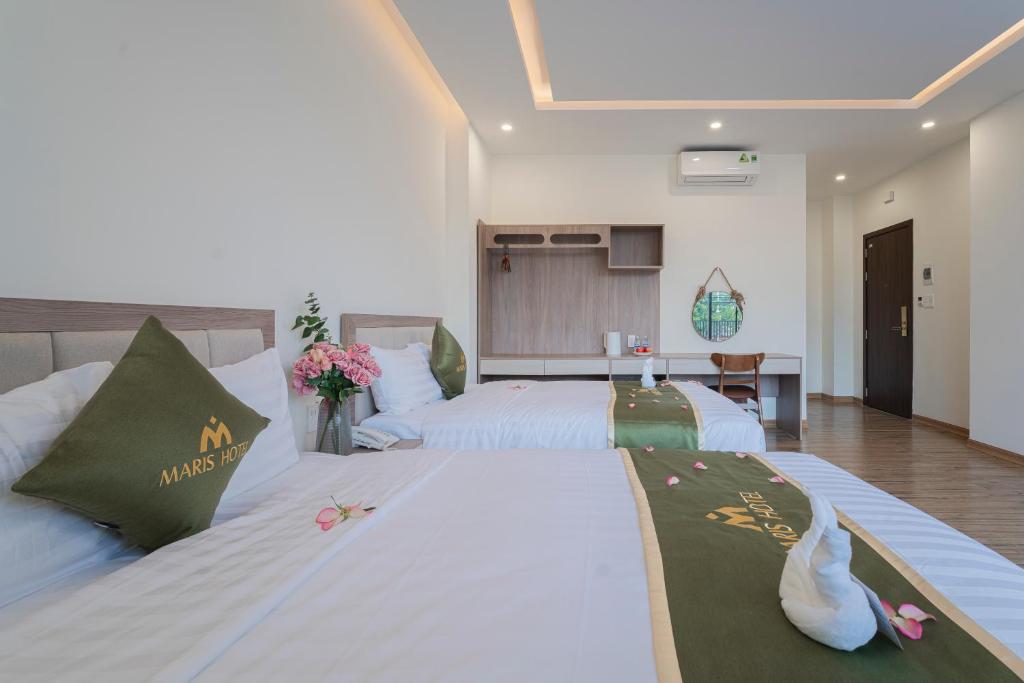 Postel nebo postele na pokoji v ubytování Maris Da Nang Hotel & Apartment