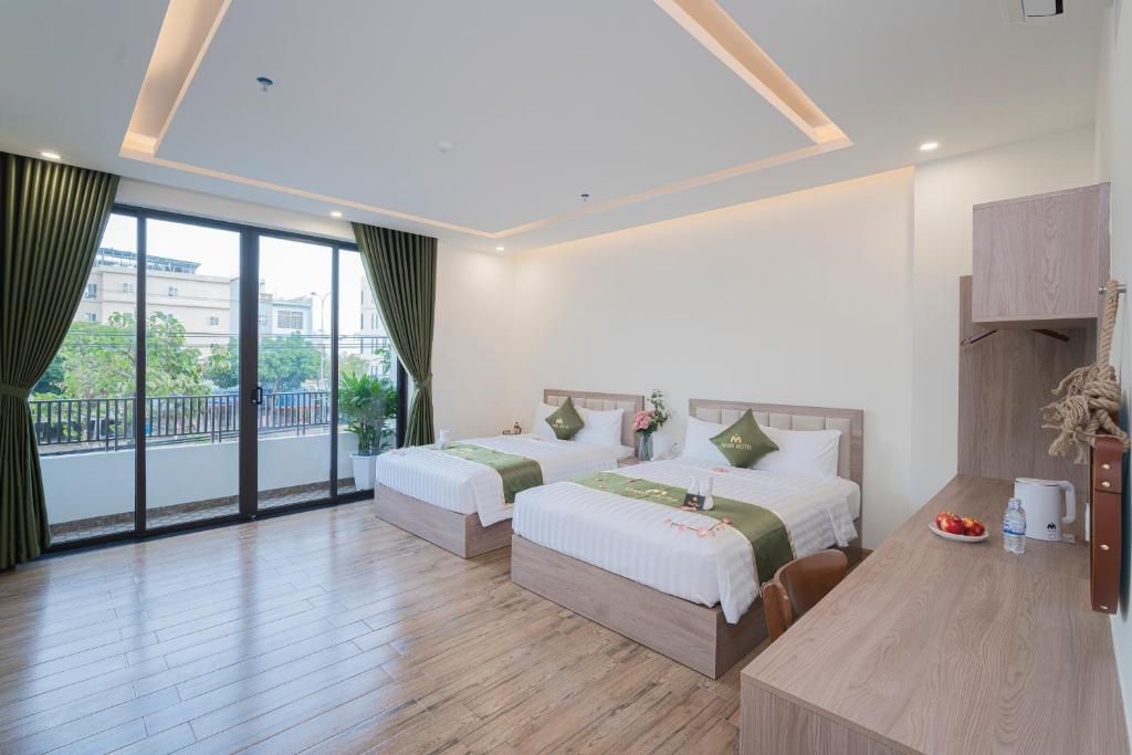 Postel nebo postele na pokoji v ubytování Maris Da Nang Hotel & Apartment