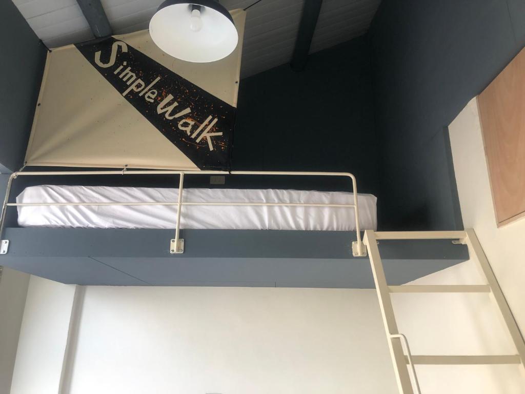 Postel nebo postele na pokoji v ubytování Simple Walk Guest House 小公寓
