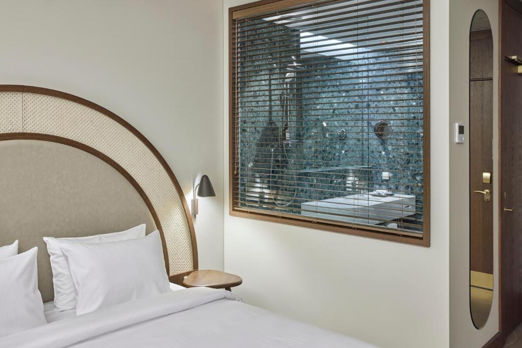 Postel nebo postele na pokoji v ubytování Neringa Hotel