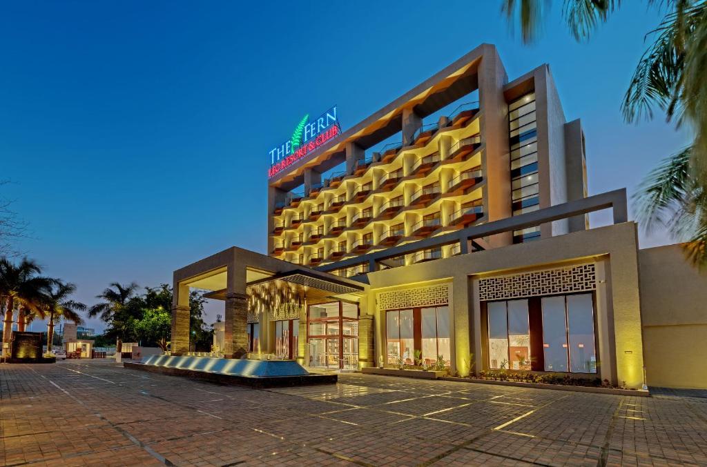a hotel on a street with palm trees at The Fern Leo Resort & Club - Junagadh, Gujarat in Junagadh