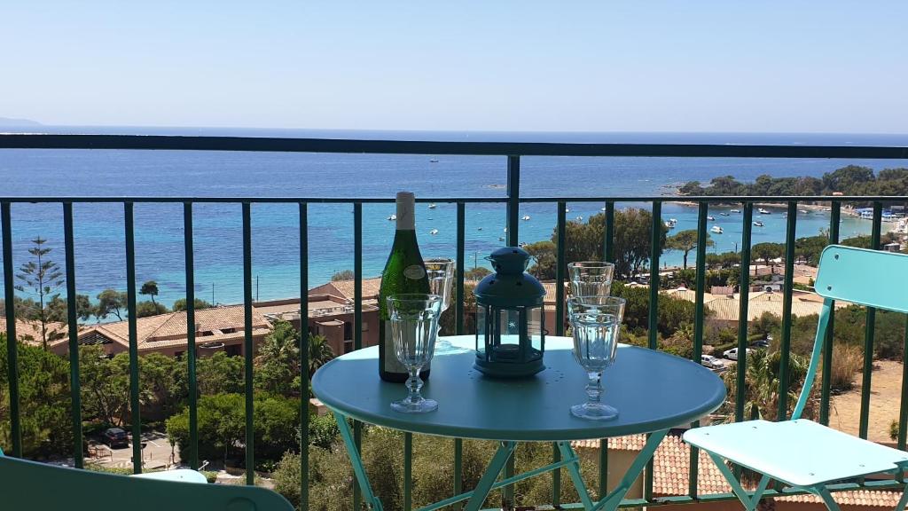 - une table avec une bouteille de vin et des verres sur un balcon dans l'établissement Santa Lina, à Ajaccio