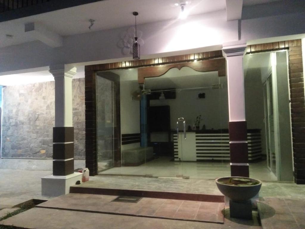 a lobby with a toilet in the middle of a building at Cumini Resort in Anuradhapura