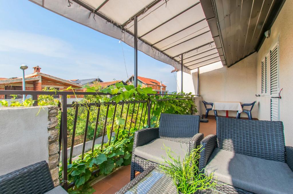 a balcony with two chairs and a table at Apartments Andrija in Pirovac