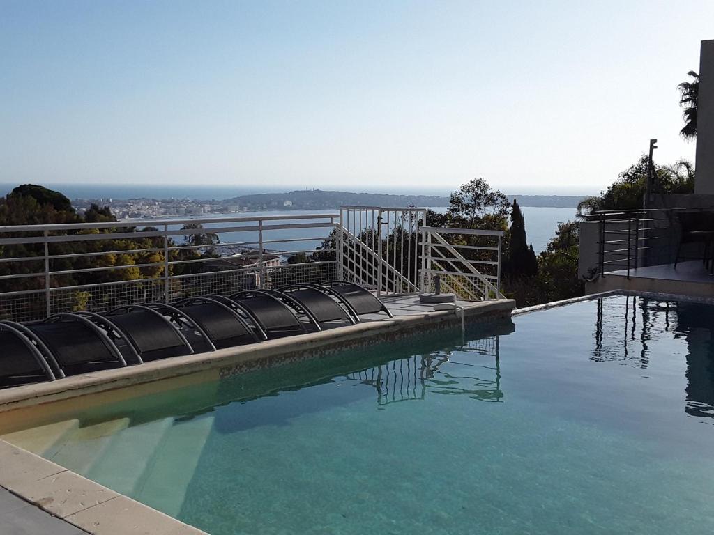 a swimming pool with a view of the ocean at Villa Alamp#supercannes #golfejuan #cannes #Mediterraneanpanoramicview #piscine #rooftop # verymodern #openliving #closebeach #closecapantibes in Vallauris