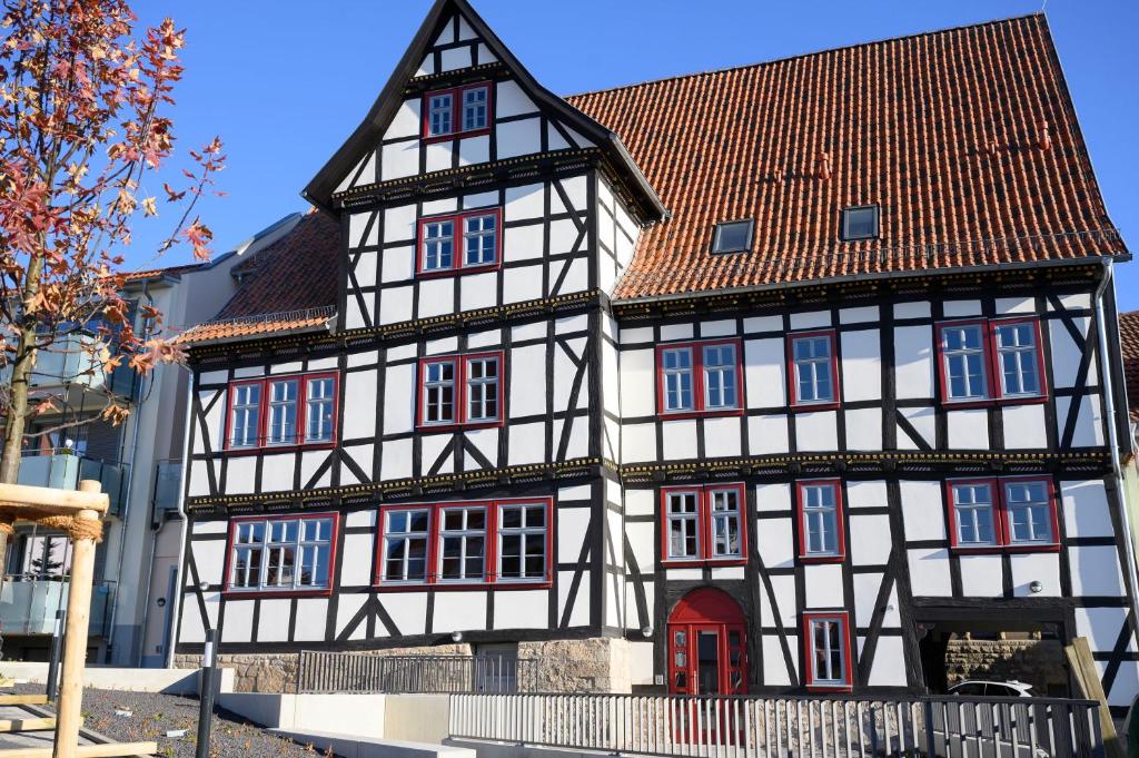 a half timbered house with a red door at Hotel1601 Inklusionsunternehmen in Treffurt