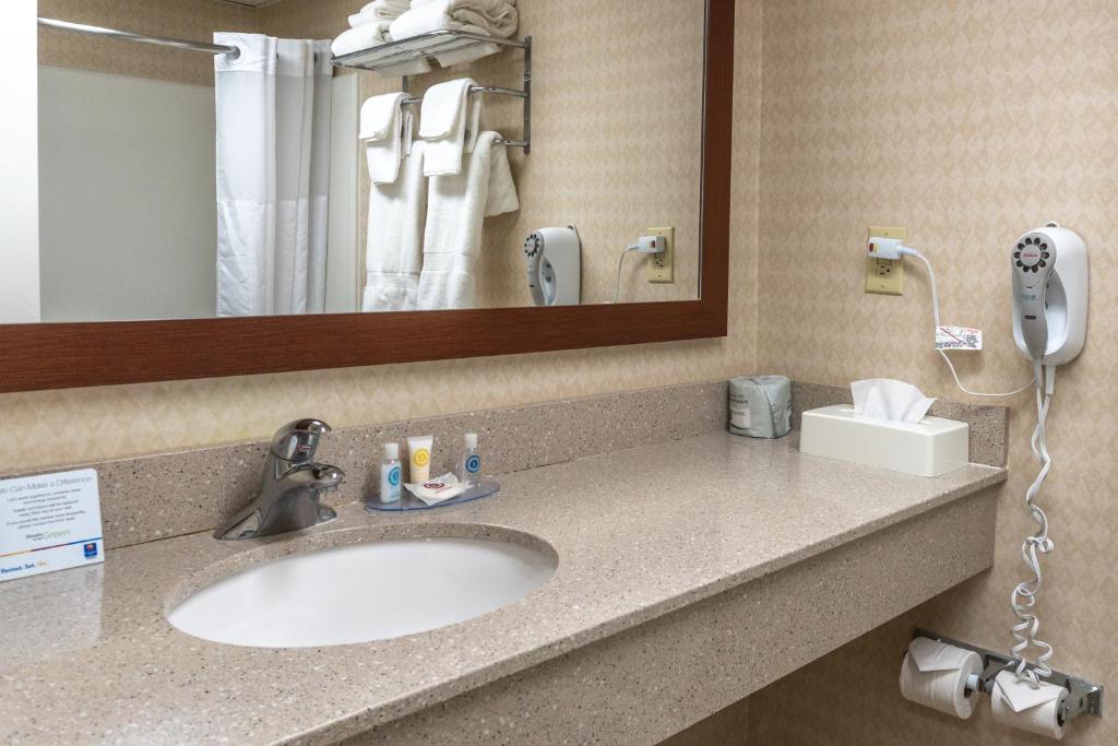 a bathroom with a sink and a mirror at Comfort Inn Ocean City Boardwalk in Ocean City