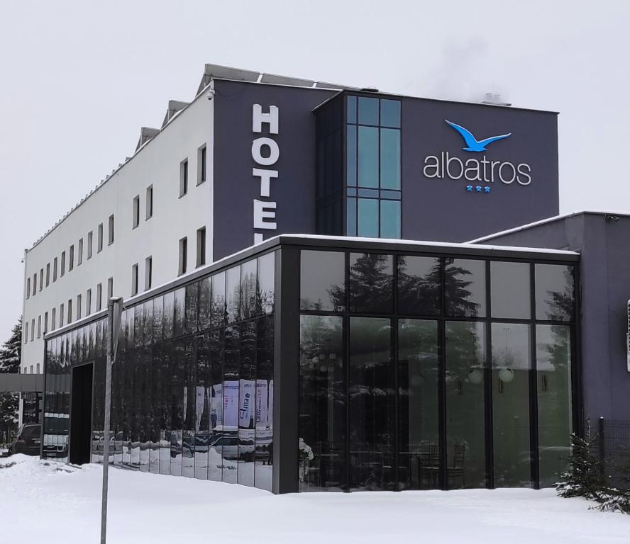 a building with a sign on the side of it at Hotel Albatros in Przemyśl