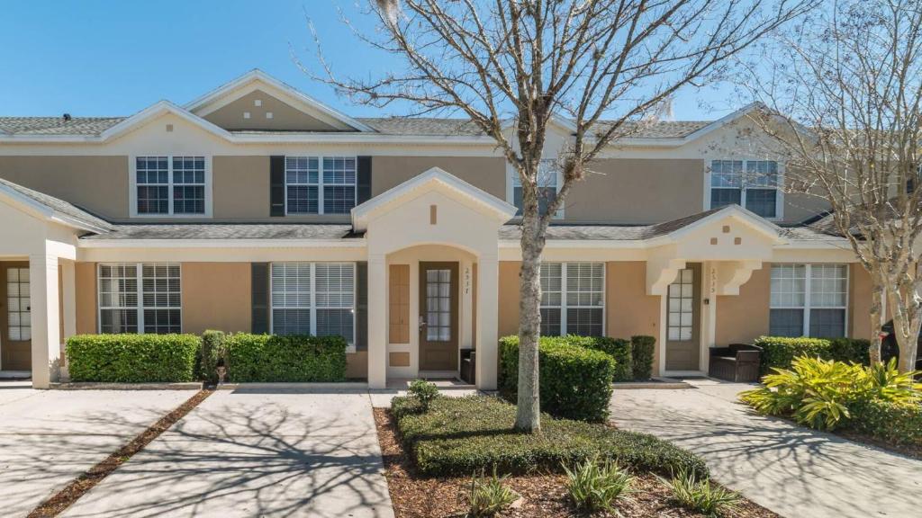 a large house with a tree in front of it at 5 Star Townhome on Windsor Hills Resort with Large Private Pool, Orlando Townhome 4922 in Orlando