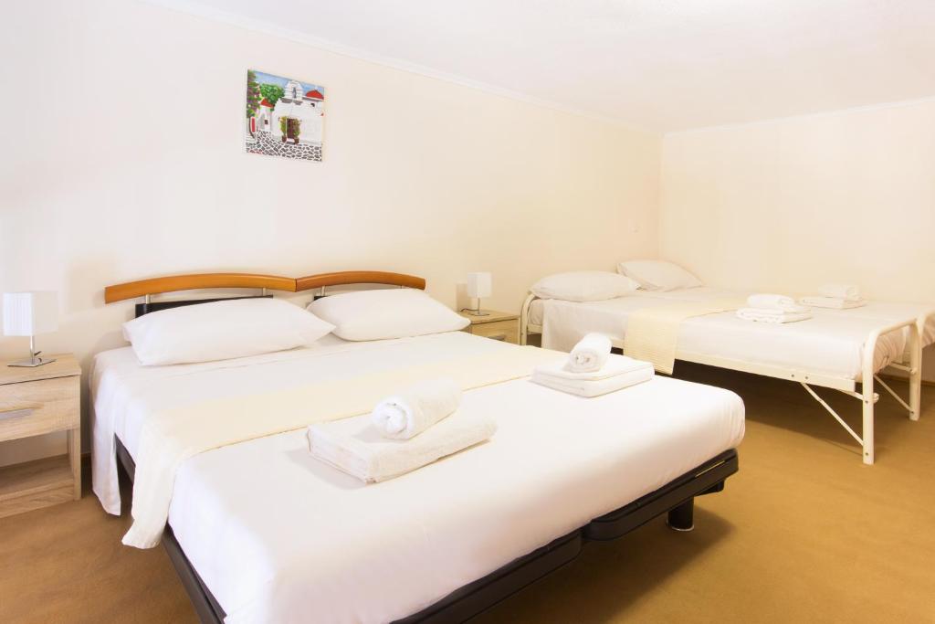 A bed or beds in a room at Rooms Kavala