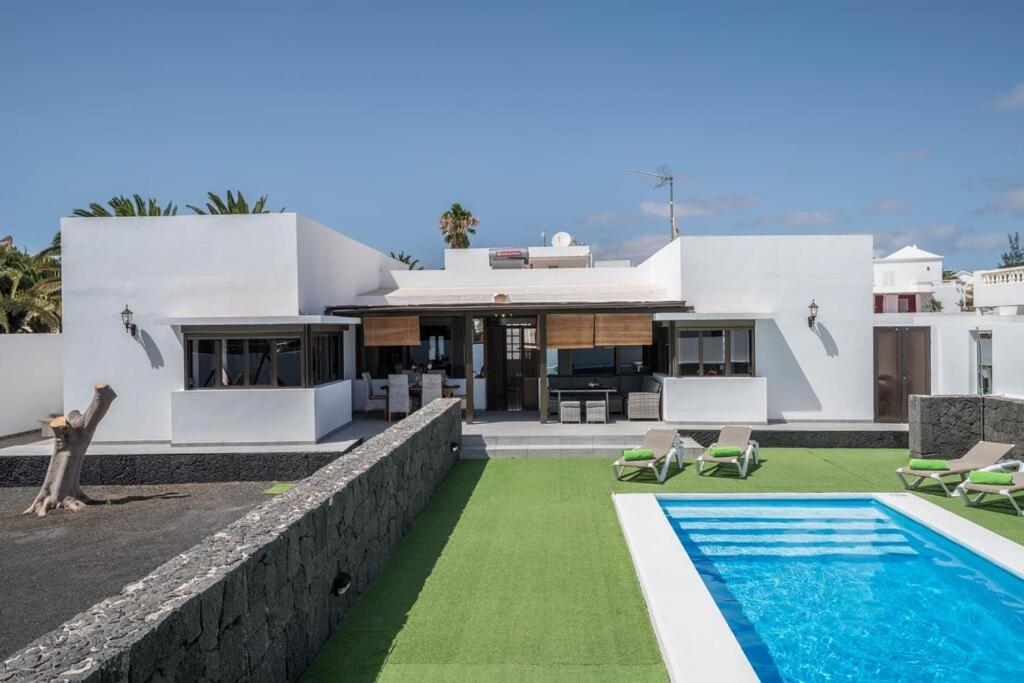 a villa with a swimming pool and a house at Villa Tuco in Costa Teguise