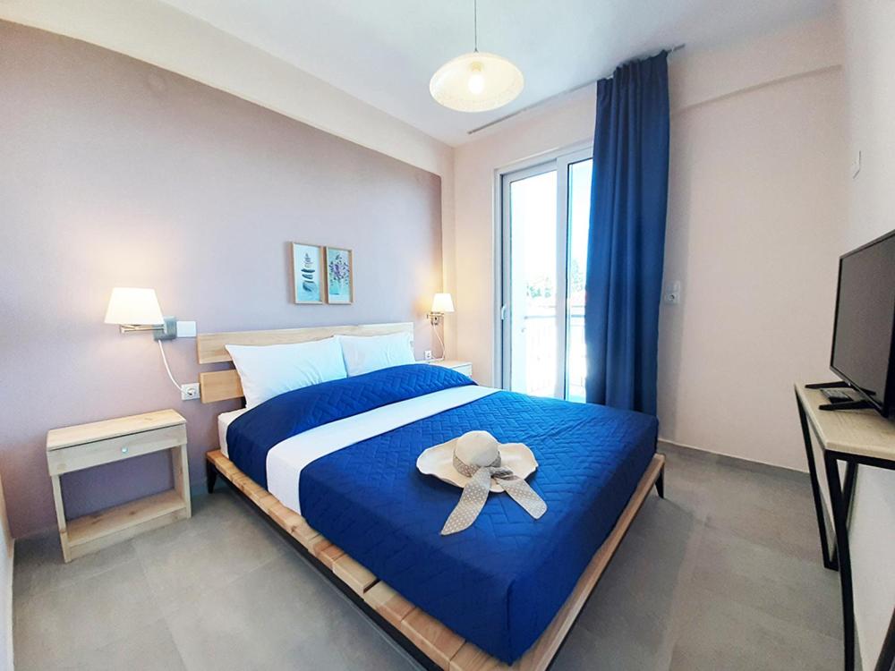 Postel nebo postele na pokoji v ubytování Manos Philoxenia