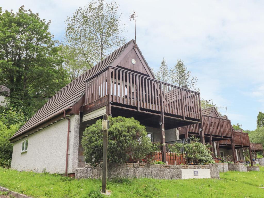 a large house with a deck on top of it at Valley Lodge 52 in Callington