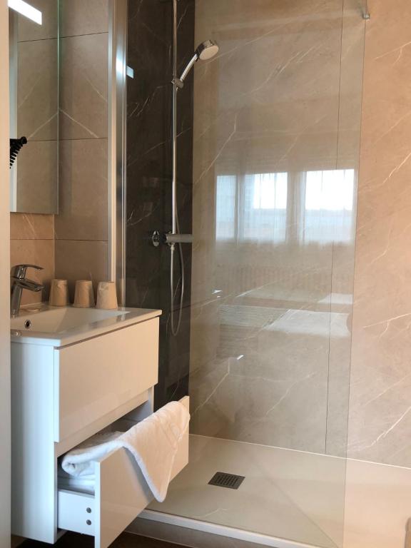a bathroom with a shower and a sink at Cit'Hotel Atlantis in Royan