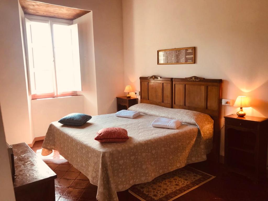 a bedroom with a bed with two pillows on it at Nel Colle in Valdottavo