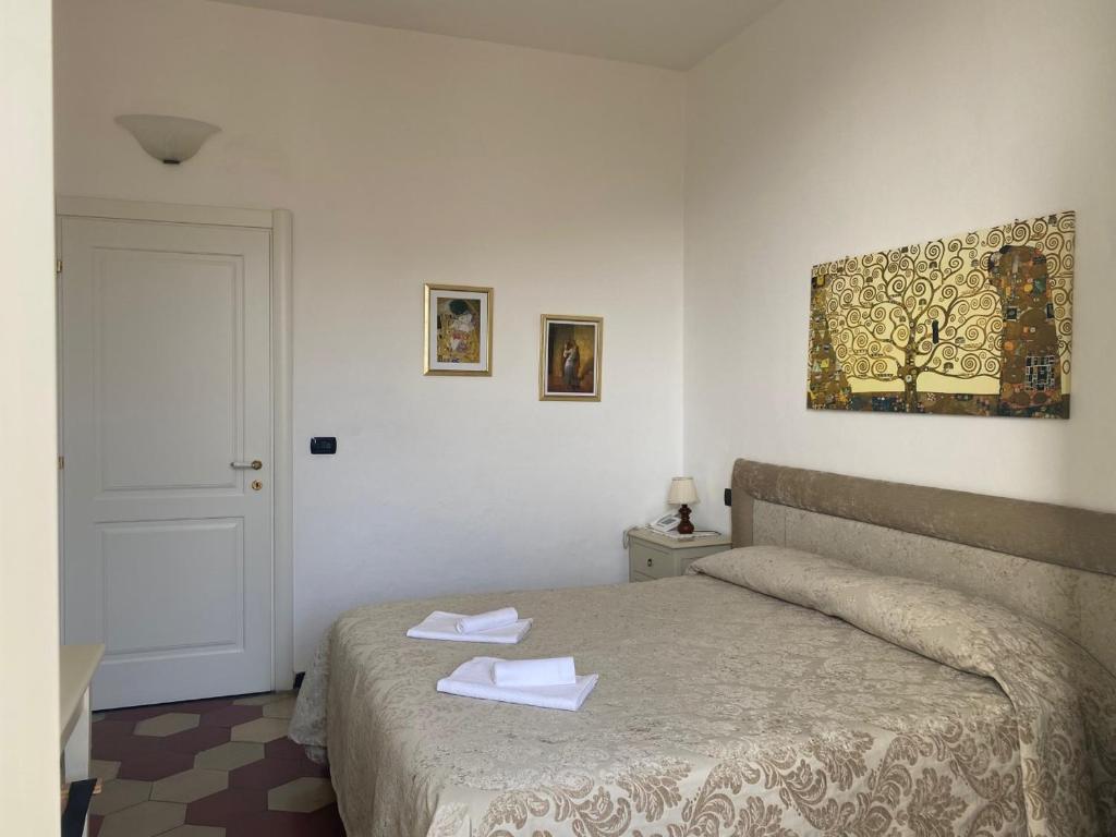 a bedroom with a bed with two towels on it at Villa Margherita in Levanto