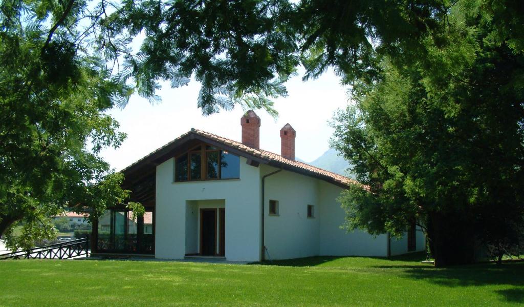 a white house with three chimneys on top of it at Hotel Aldama Golf in Quintana de Llanes
