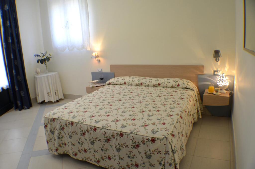 a hotel room with a bed and a window at Masseria Asciano in Ostuni