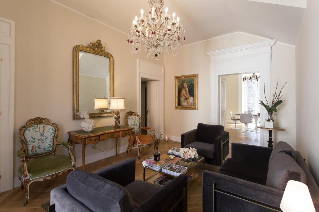 a living room filled with furniture and a chandelier at GMarconi Suites in Campobasso