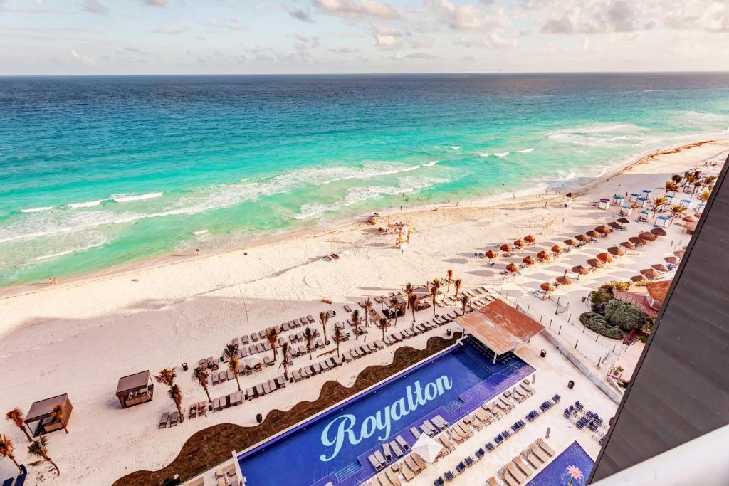 an aerial view of a beach with chairs and umbrellas at Royalton CHIC Cancun, An Autograph Collection All-Inclusive Resort - Adults Only in Cancún