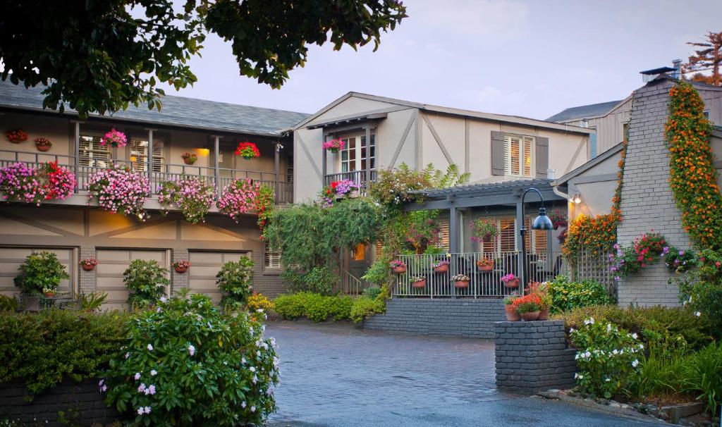 a house with flowers on the side of it at Carmel Country Inn in Carmel