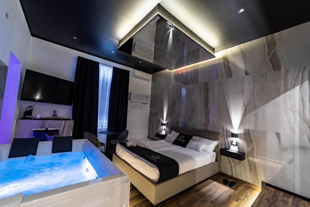 a bedroom with a bed and a tub at Maximum Suite & Spa in Palermo